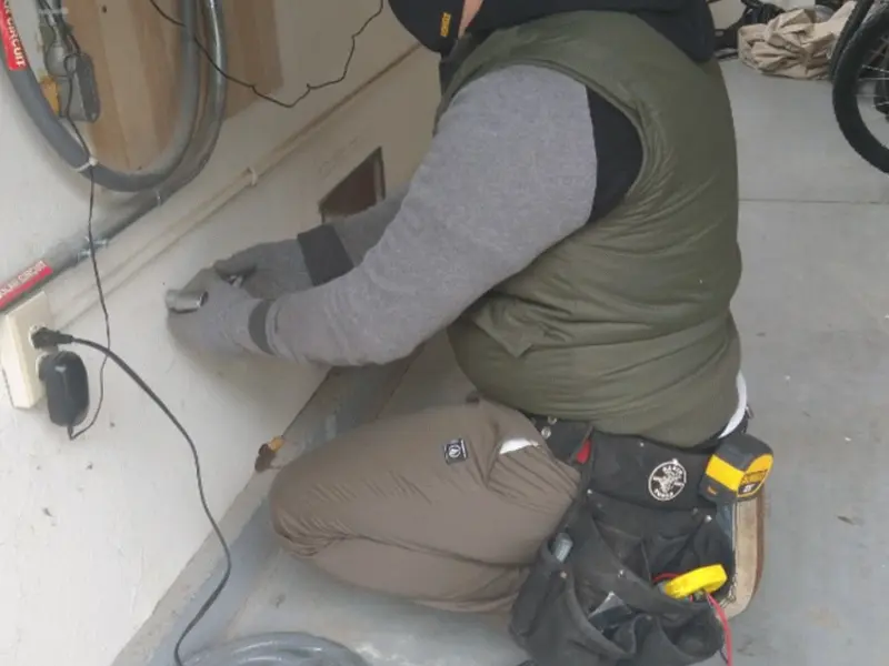 Electrician performing outlet wiring in a Moorpark garage